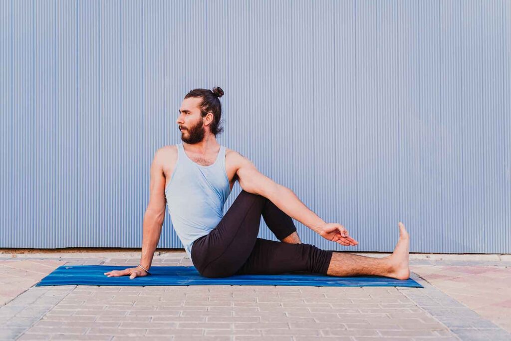 Half Lord of the Fishes Pose in yoga man doing half lord of the fishes yoga pose